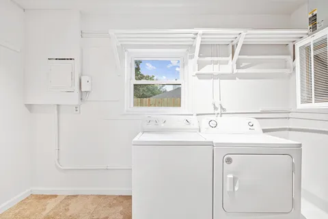 a view of a sink and a washer dryer