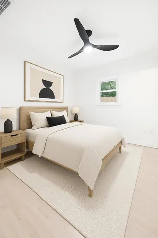 a bedroom with a bed and a painting on the wall