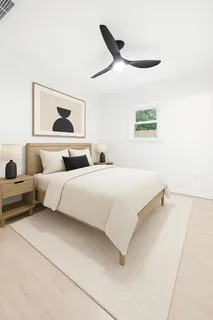 a bedroom with a bed and a painting on the wall