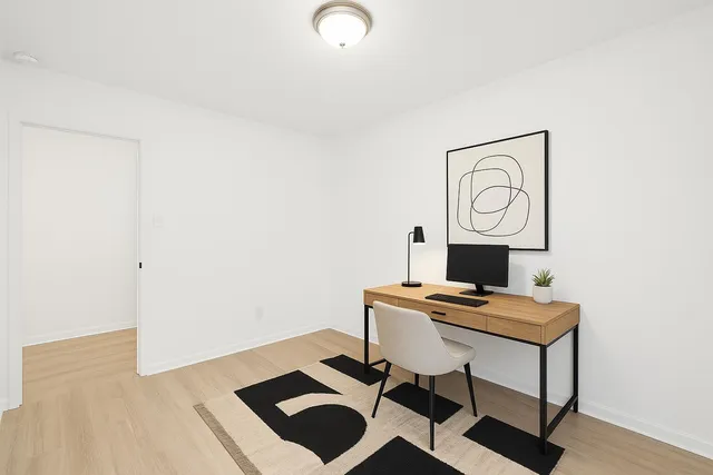 a view of workspace with wooden floor