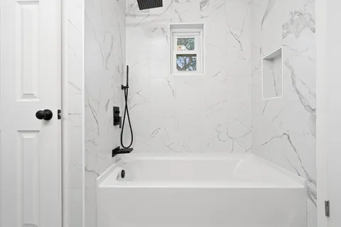 a bathroom with a bath tub