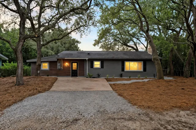 a view of a house with a yard and garage