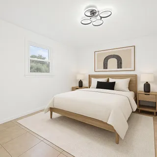 a bedroom with a bed and a painting on the wall