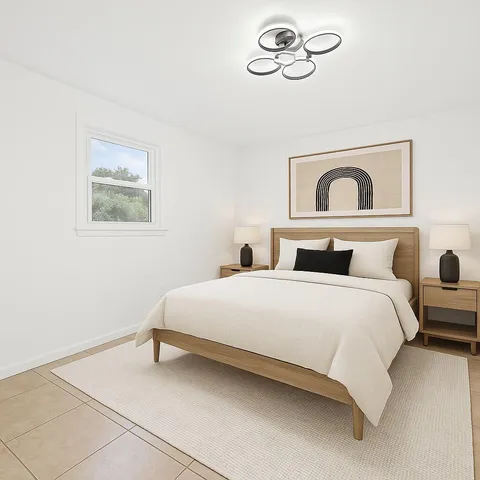 a bedroom with a bed and a painting on the wall