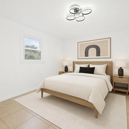 a bedroom with a bed and a painting on the wall