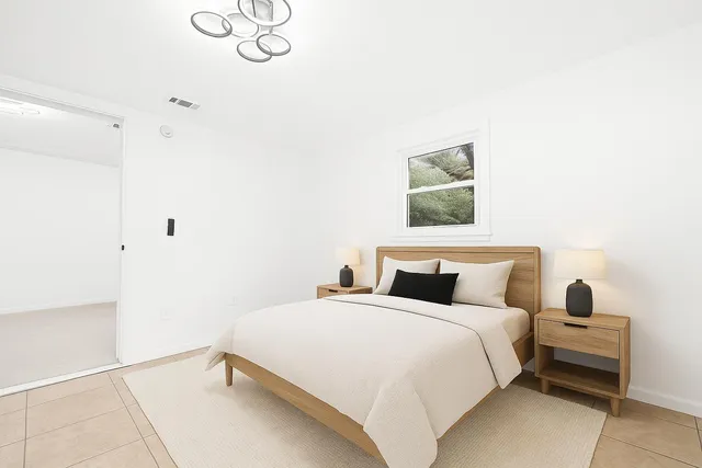 a bedroom with a bed and a window