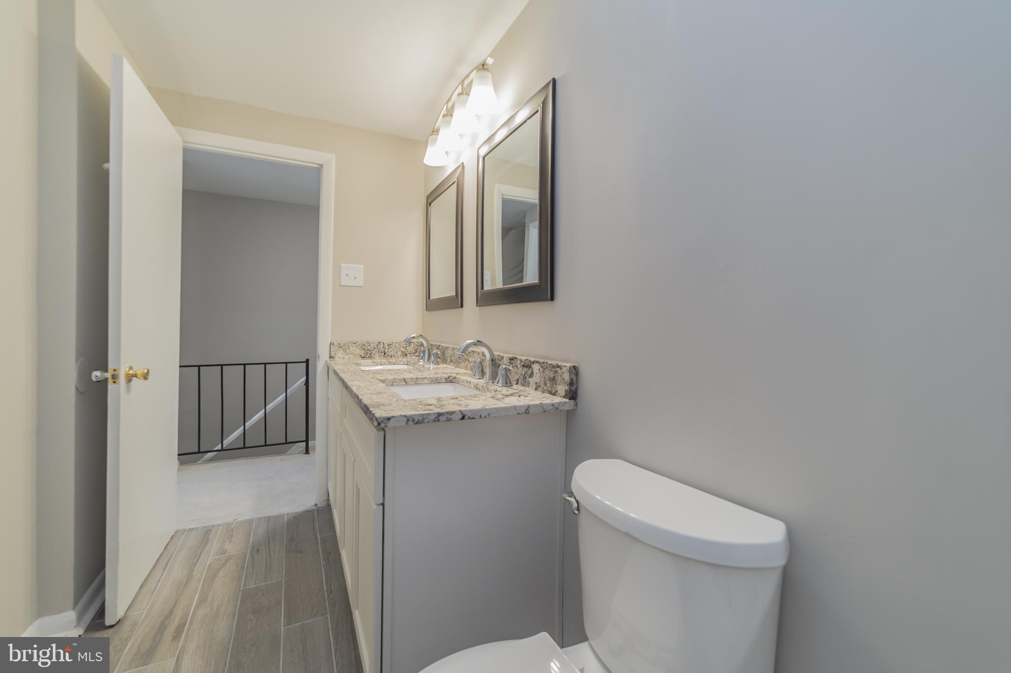 9349 Reader Lane Columbia, MD 21045 - Photo 19 of 32 a bathroom with a sink a toilet and vanity