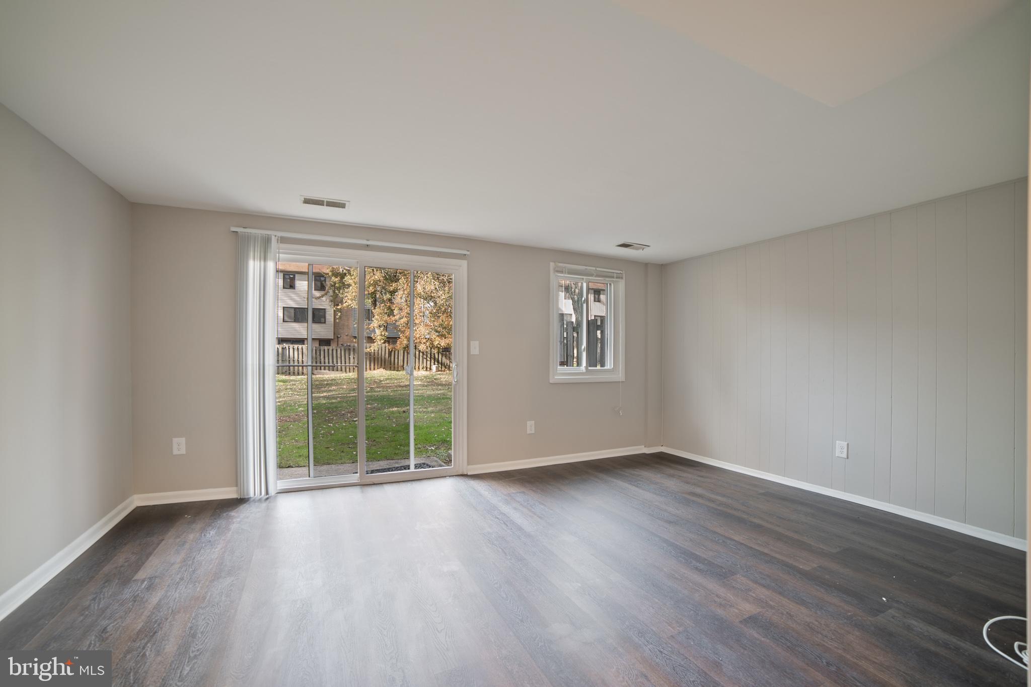9349 Reader Lane Columbia, MD 21045 - Photo 26 of 32 a view of an empty room with wooden floor and a window