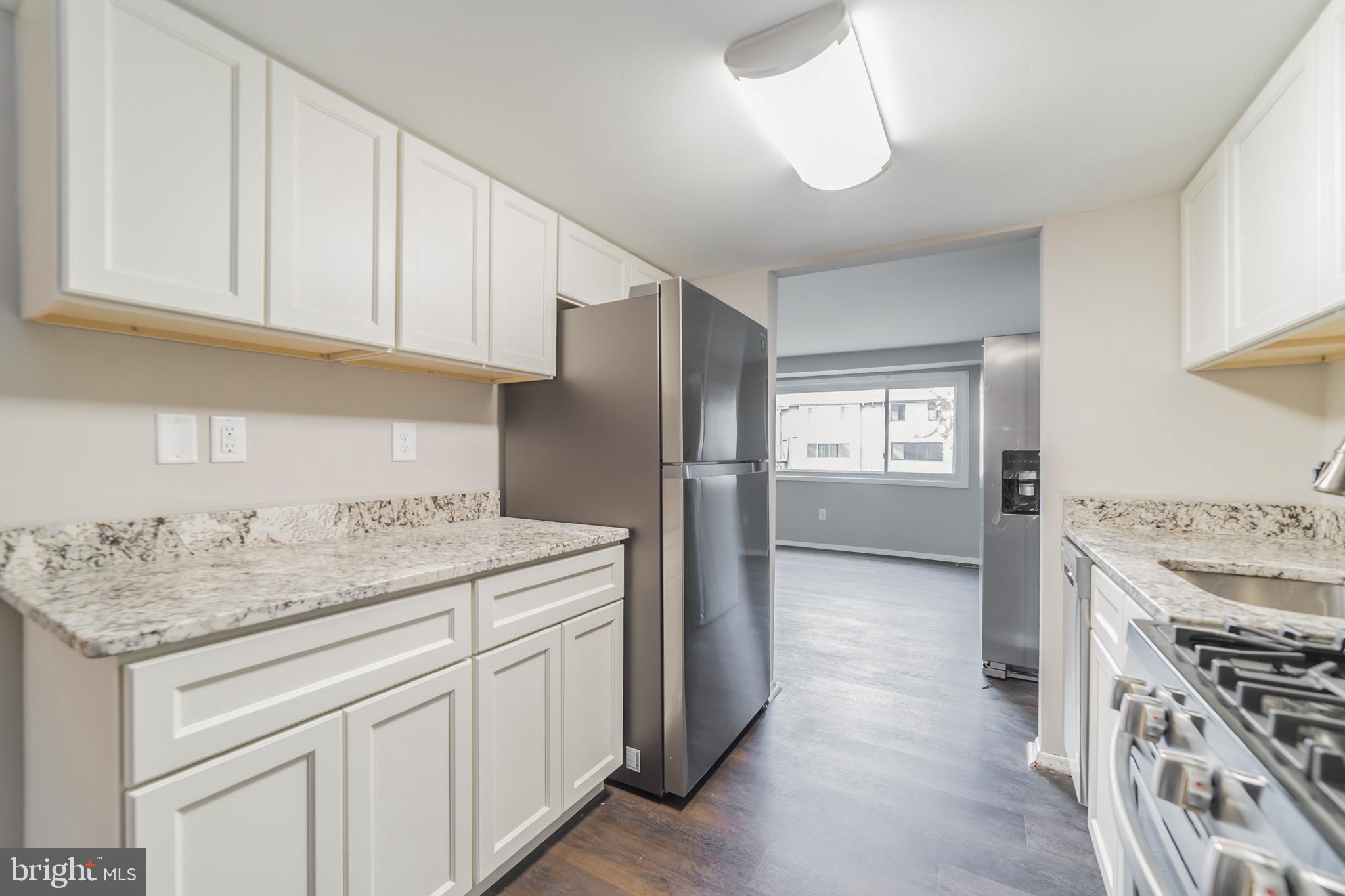 9349 Reader Lane Columbia, MD 21045 - Photo 5 of 32 a kitchen with a sink stove and refrigerator
