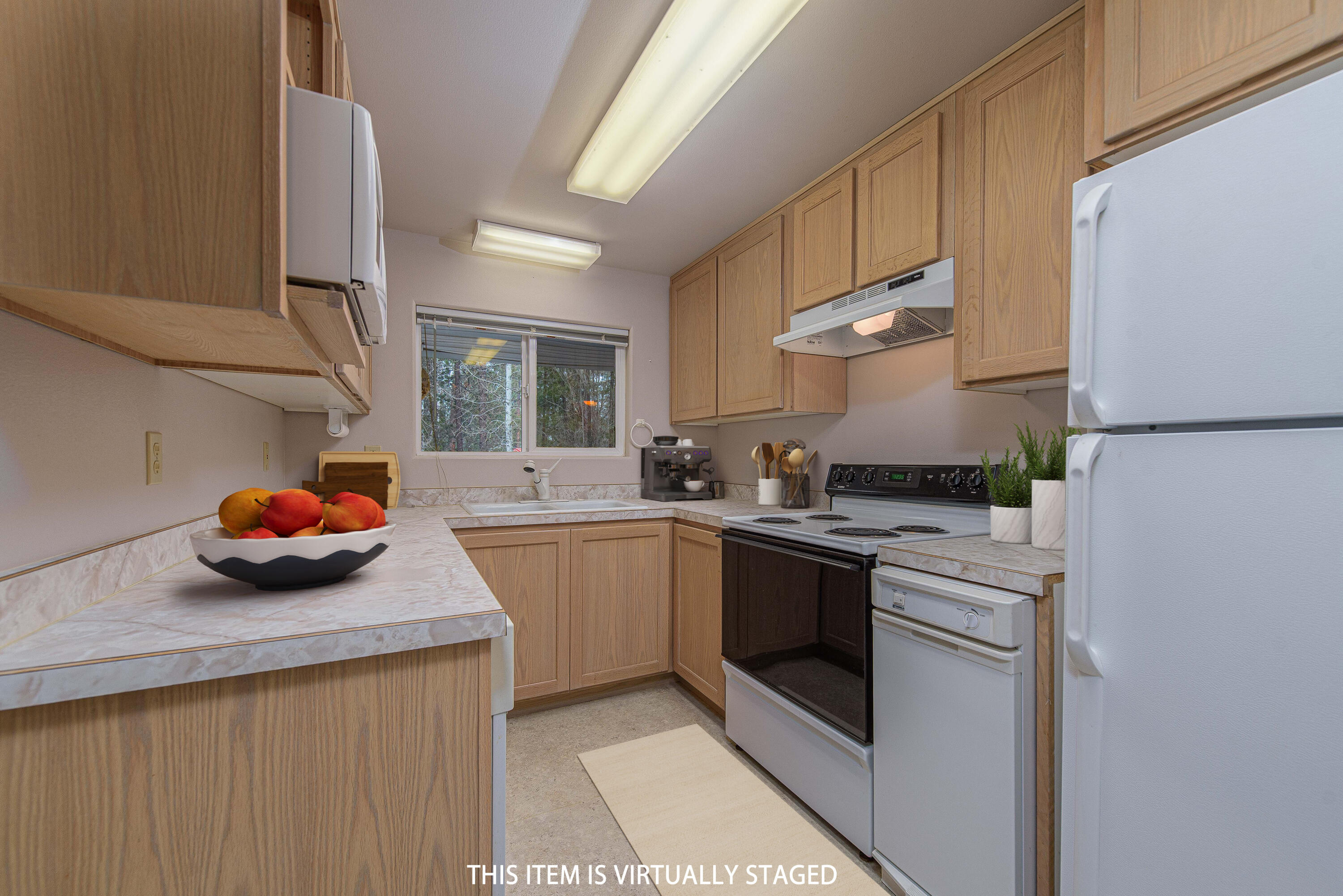 138722 Rhododendron Street Gilchrist, OR 97737 - Photo 16 of 36 a kitchen with stainless steel appliances a sink a stove a refrigerator and cabinets