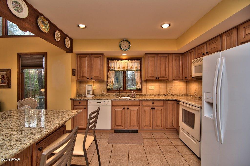 3042 Northgate Road Lake Ariel, PA 18436 - Photo 6 of 37 a kitchen with granite countertop stainless steel appliances a stove oven and sink