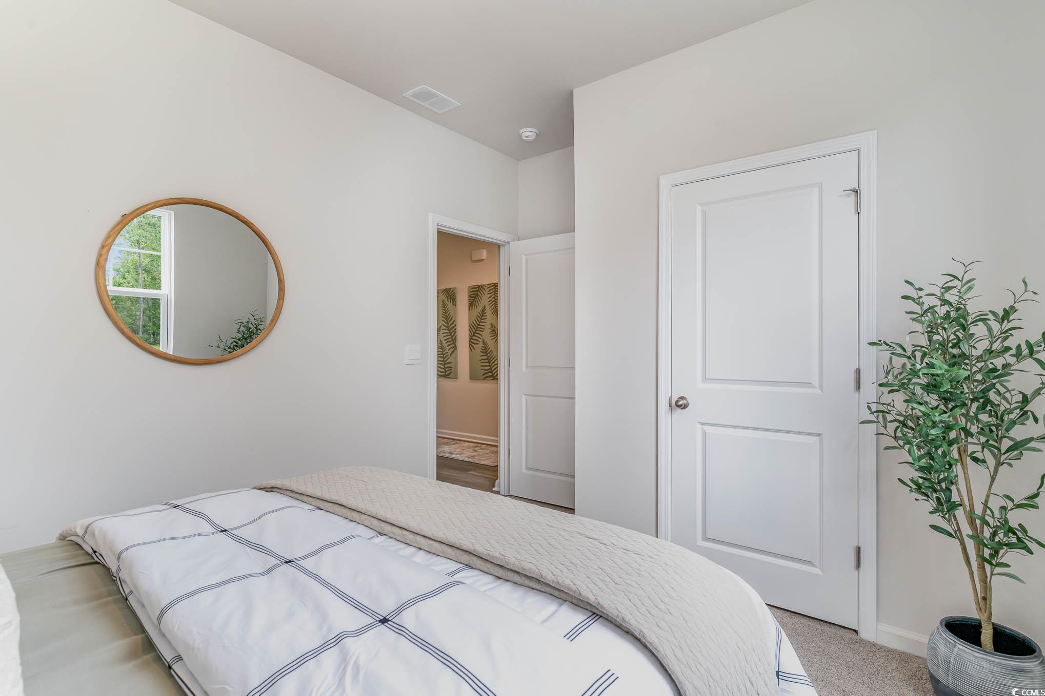 524 Duvall Street Longs, SC 29568 - Photo 4 of 20 Bedroom with light carpet and baseboards