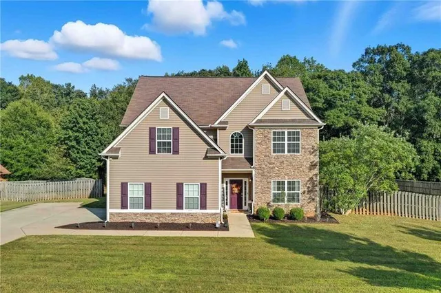 a front view of a house with a garden