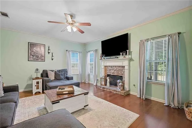 a living room with furniture a flat screen tv and a fireplace
