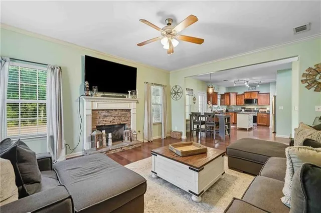 a living room with furniture fireplace and a flat screen tv
