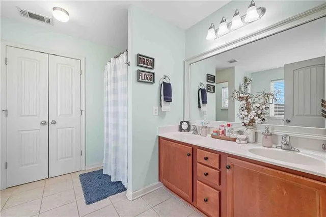 a spacious bathroom with double sink and a mirror