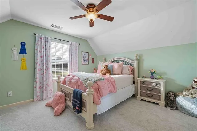 a spacious bedroom with a bed and a window