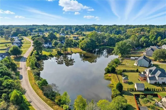 an aerial view of a house with a lake view