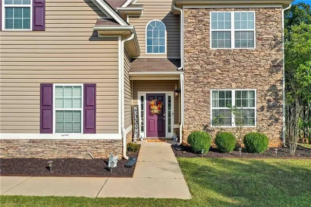 a front view of a house with a yard