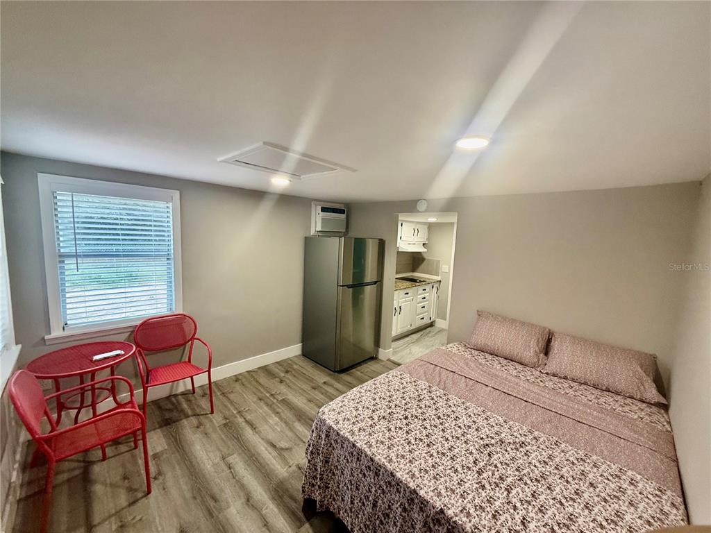 3125 Simpson Road Kissimmee, FL 34744 - Photo 2 of 7 a bedroom with a bed and a chair