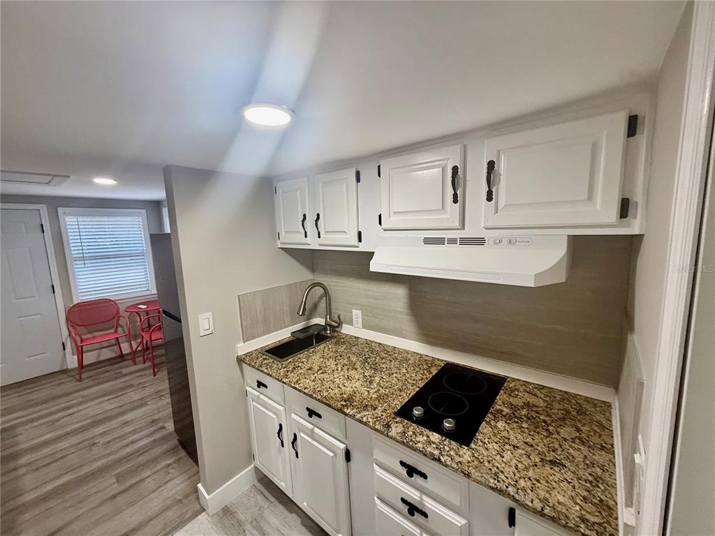 3125 Simpson Road Kissimmee, FL 34744 - Photo 4 of 7 a kitchen with stainless steel appliances granite countertop a stove and a sink
