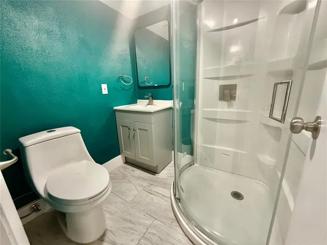 a bathroom with a sink mirror vanity and toilet