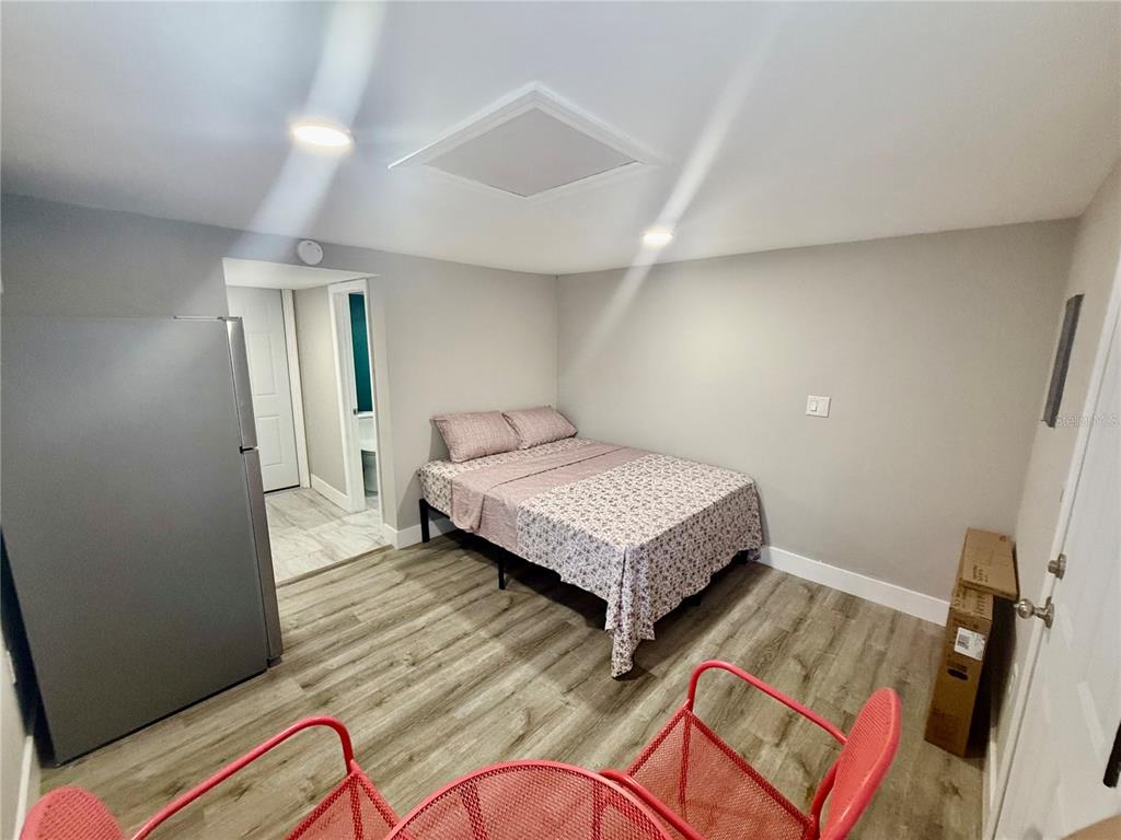 3125 Simpson Road Kissimmee, FL 34744 - Photo 7 of 7 a bedroom with a bed and wooden floor