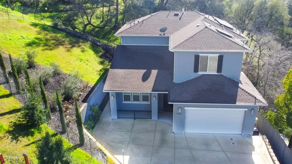 a aerial view of a house with swimming pool and sitting space