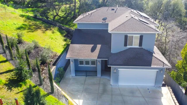 a aerial view of a house with swimming pool and sitting space