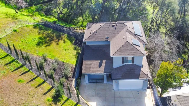 an aerial view of a house with a yard