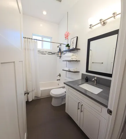 a view of a hallway with wooden floor and closet