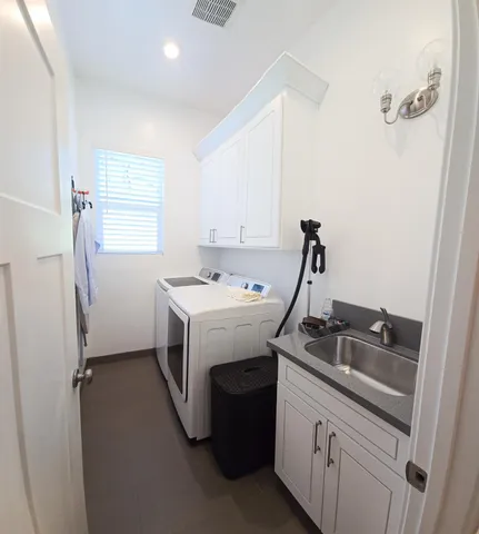 a view of a hallway with wooden floor and a refrigerator