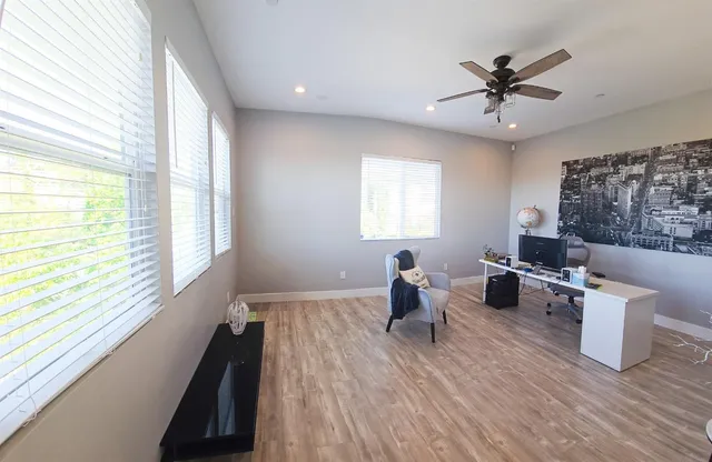 a view of backyard with table and chairs and potted plants