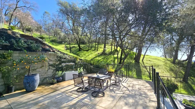 a view of backyard with seating area and trees around