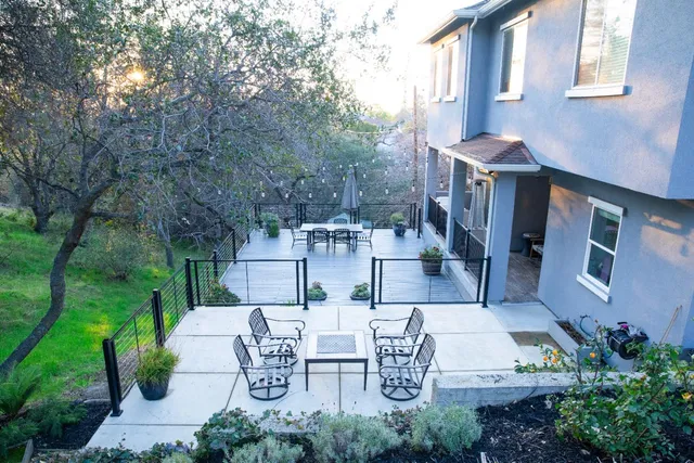 a view of a patio with table and chairs and potted plants