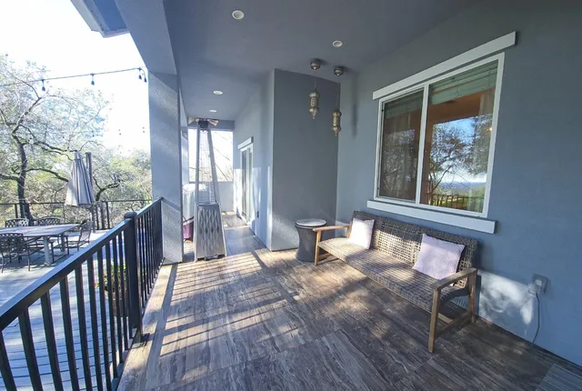 a view of a balcony with trees