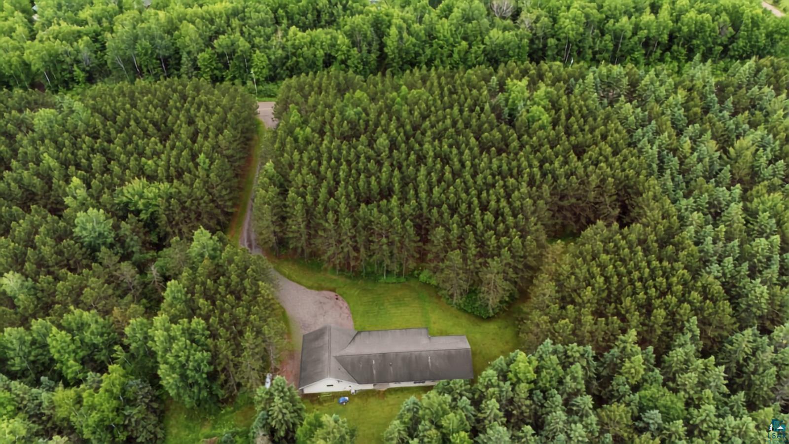 41 East Stark Road Esko, MN 55733 - Photo 18 of 19 Expansive forested property featuring a single-story residence with a dark-pitched roof, surrounded by mature evergreen and deciduous trees
