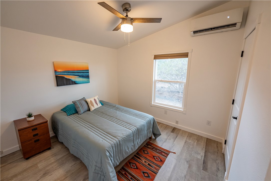 2765 North Silver Springs Road Kingman, AZ 86401 - Photo 24 of 60 a bedroom with a bed and wooden floor