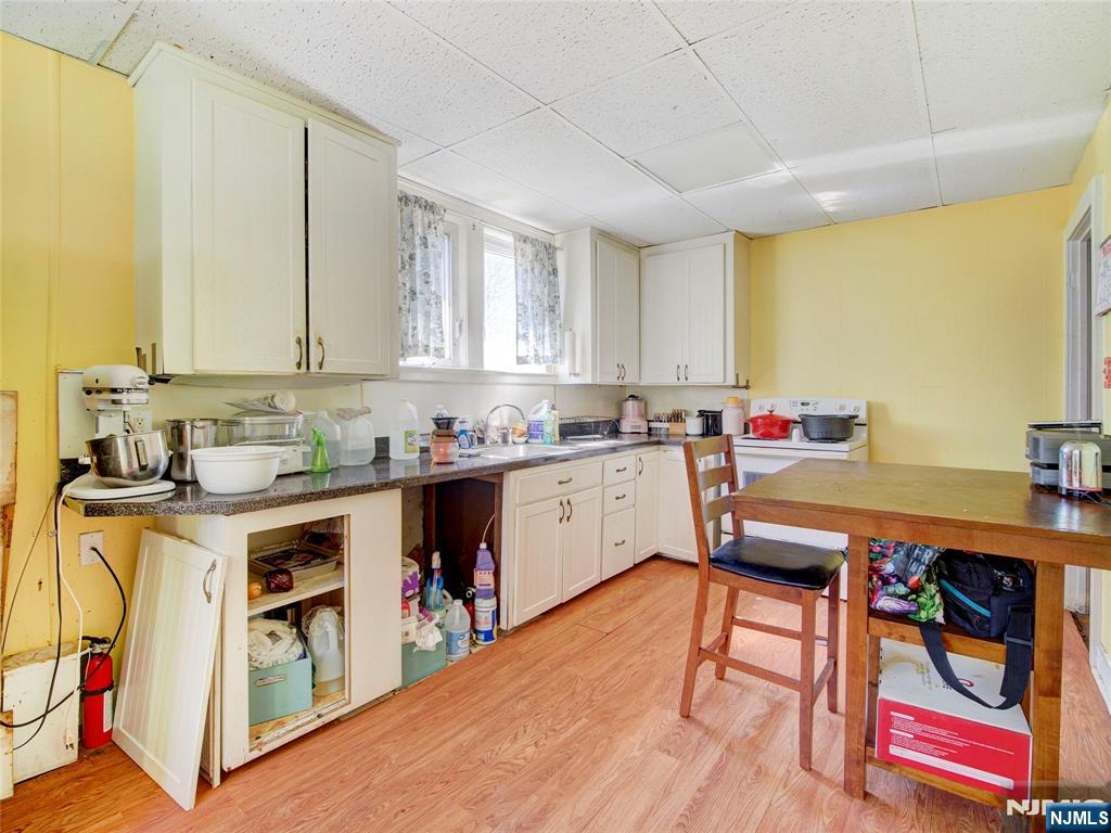 416 Jerusalem Road Scotch Plains, NJ 07076 - Photo 16 of 26 a kitchen that has a lot of cabinets in it and wooden floor