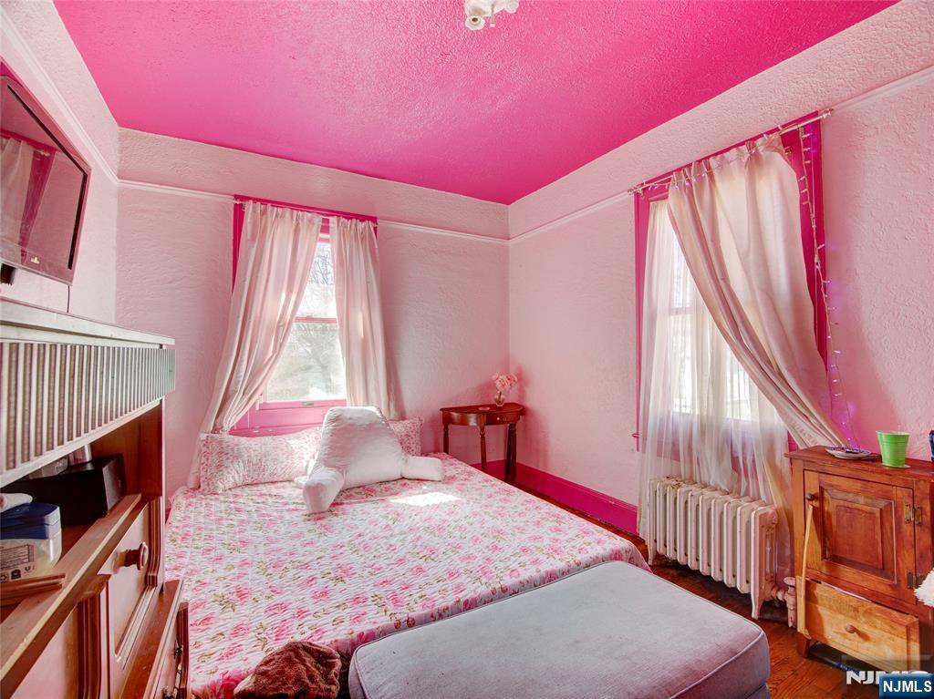 416 Jerusalem Road Scotch Plains, NJ 07076 - Photo 19 of 26 a bedroom with a bed and wooden floor