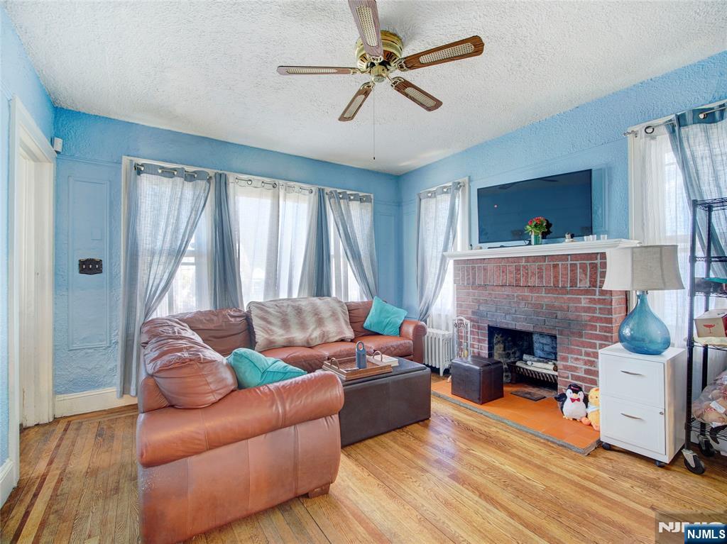 416 Jerusalem Road Scotch Plains, NJ 07076 - Photo 22 of 26 a living room with furniture and a fireplace