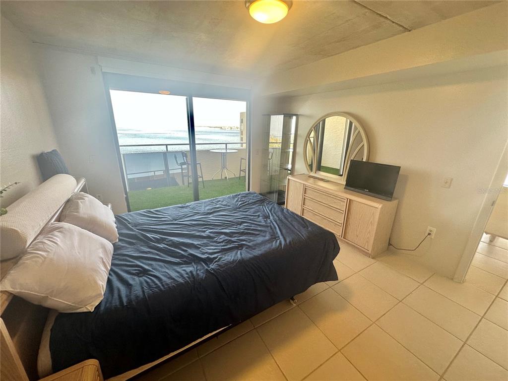 6009 Sea Ranch Drive, Unit 804 Hudson, FL 34667 - Photo 14 of 73 a bedroom with a bed and window