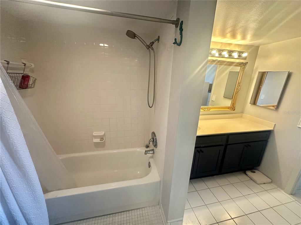 6009 Sea Ranch Drive, Unit 804 Hudson, FL 34667 - Photo 16 of 73 a bathroom with a bathtub and a shower