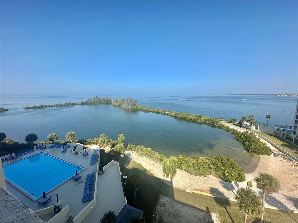 6009 Sea Ranch Drive, Unit 804 Hudson, FL 34667 - Photo 19 of 73 a view of a lake with couches in the patio
