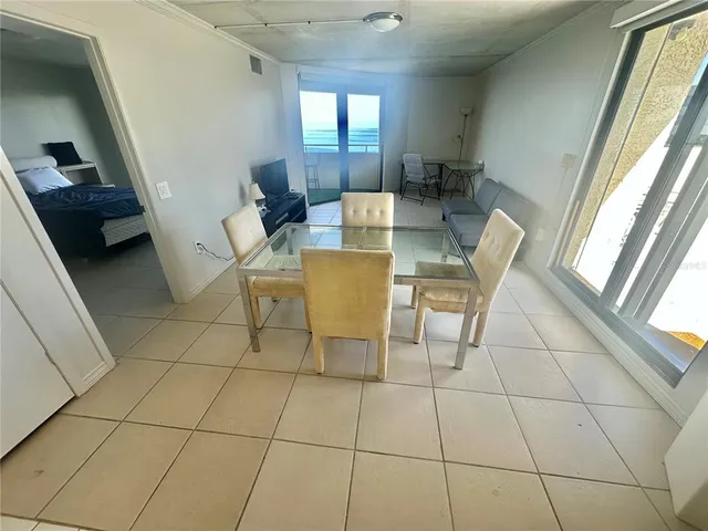 a view of a dining room with furniture and a window