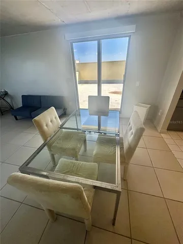 a living room with a table and a large window