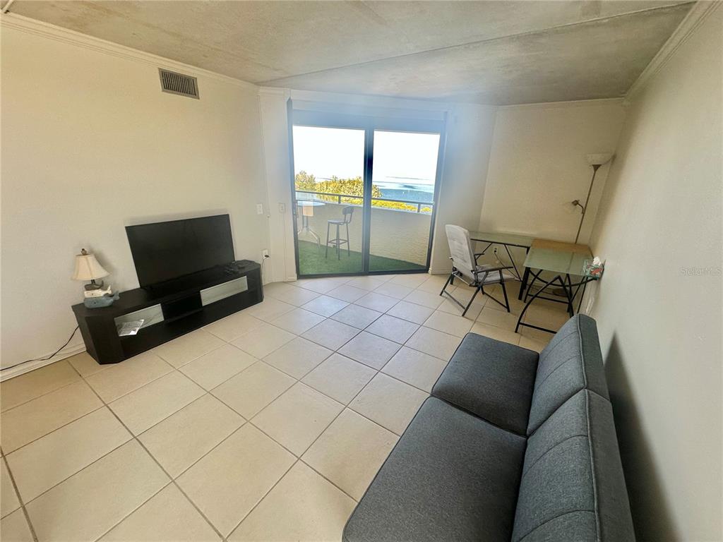 6009 Sea Ranch Drive, Unit 804 Hudson, FL 34667 - Photo 8 of 73 a living room with furniture and a flat screen tv