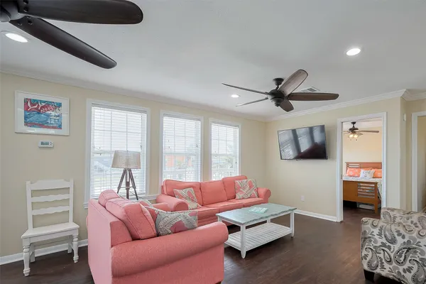 a living room with furniture a ceiling fan and a window