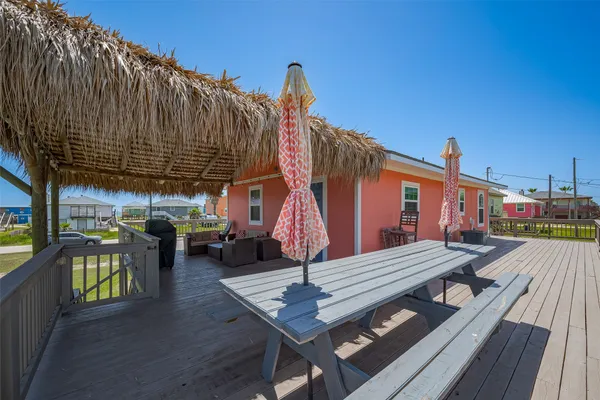 a view of a house with barbeque oven and furniture