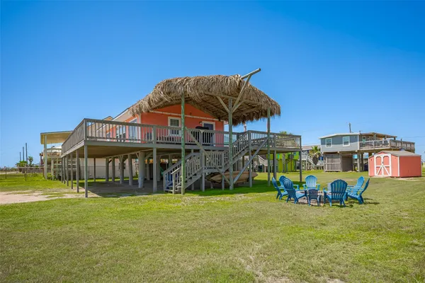 a view of a house with a yard and sitting area